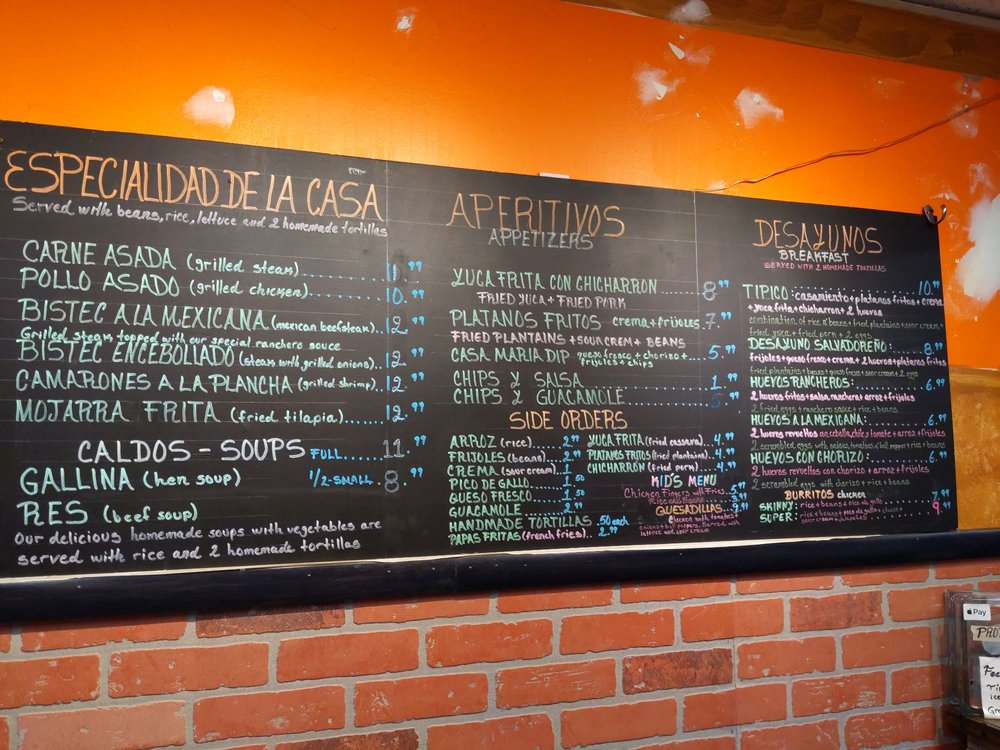 Casa María's handwritten specialties menu board on the dining-room wall